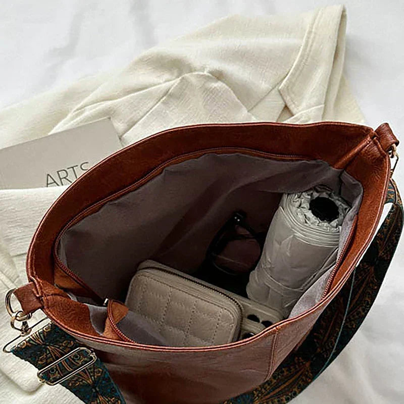 Stylish women's accessory: A bohemian shoulder bag with a unique and decorative patterned strap.