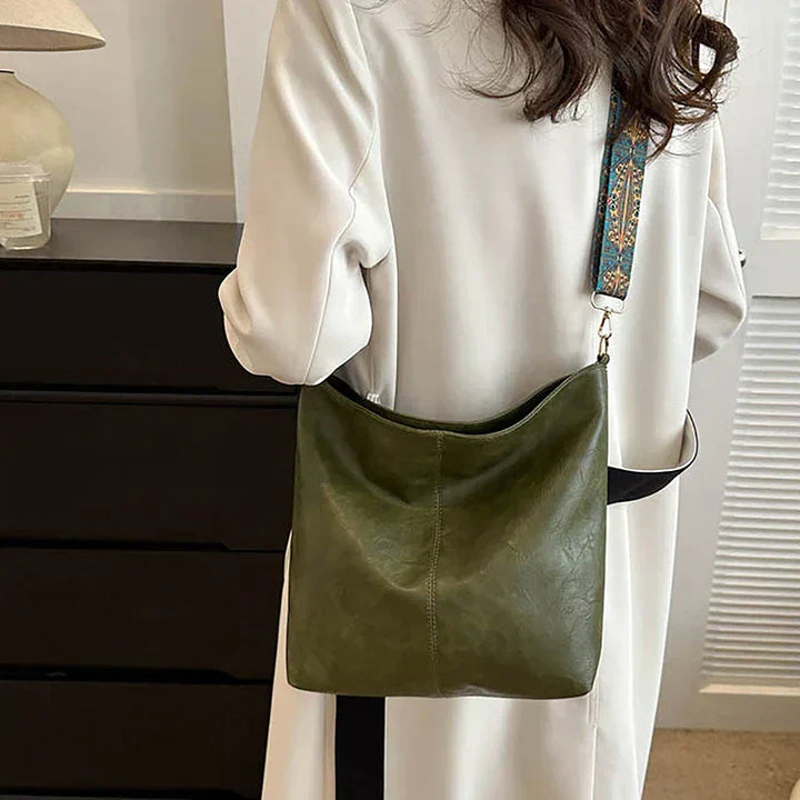 Stylish women's bohemian handbag with a wide, decorative patterned strap, ideal for a casual look.