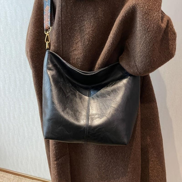 Women's shoulder bag, bohemian style, showcasing a beautifully patterned and colorful strap.