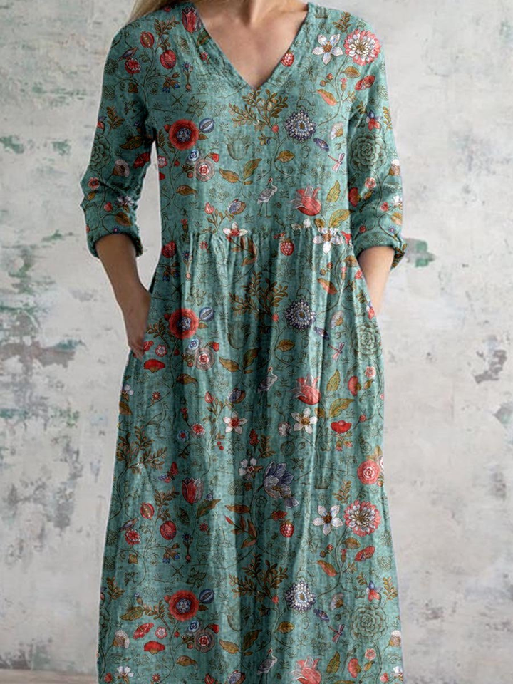 Flowy women's boho maxi dress, featuring a vibrant floral print, flattering V-neck, and practical three-quarter sleeves.