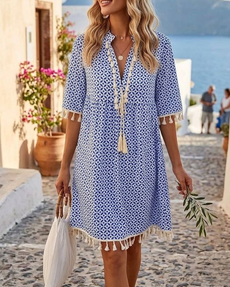 Women's boho mini tunic dress with vibrant geometric print and playful tassel hem, perfect for summer.