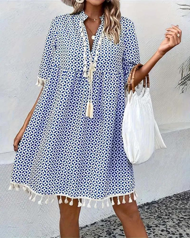 Stylish women's geometric print boho mini tunic dress with tassel trim, a versatile casual summer outfit.