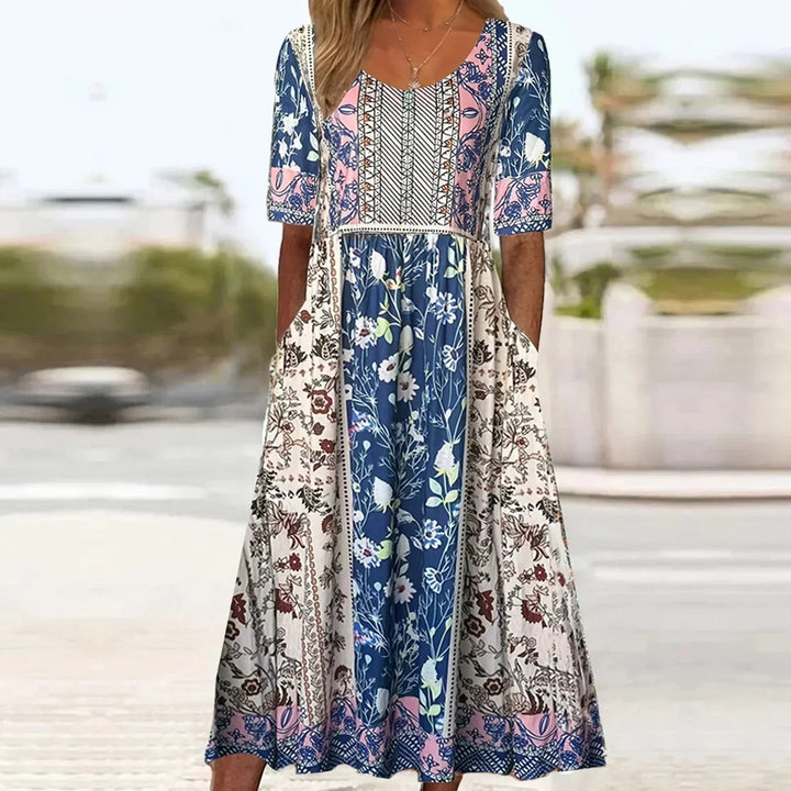 Boho midi dress for women featuring a vibrant floral print, practical pockets, and a comfortable gathered waist. Ideal for summer.