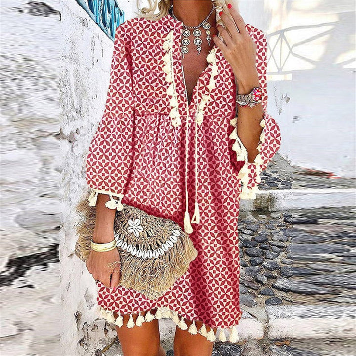 Casual women's V-neck mini dress with a bohemian flair, tassels, bell sleeves. Perfect for spring & summer fashion.
