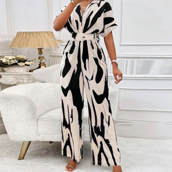 Casual women's print jumpsuit with V-neck & short sleeves. Ideal loose fit summer outfit for beach, travel & everyday wear.
