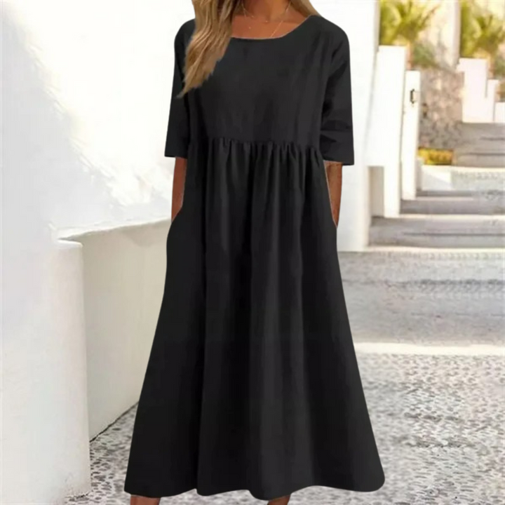 Elegant A-line women's summer midi dress featuring a smocked waist & short sleeves for vacation.