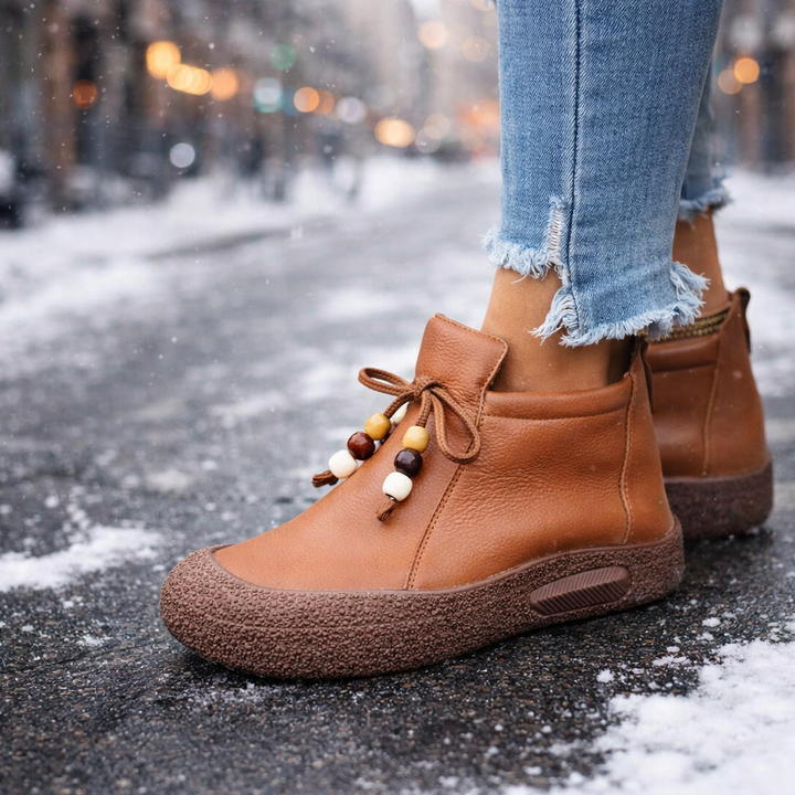 Close-up of women's leather ankle boots in a rich tan color, emphasizing comfort and orthopedic features.