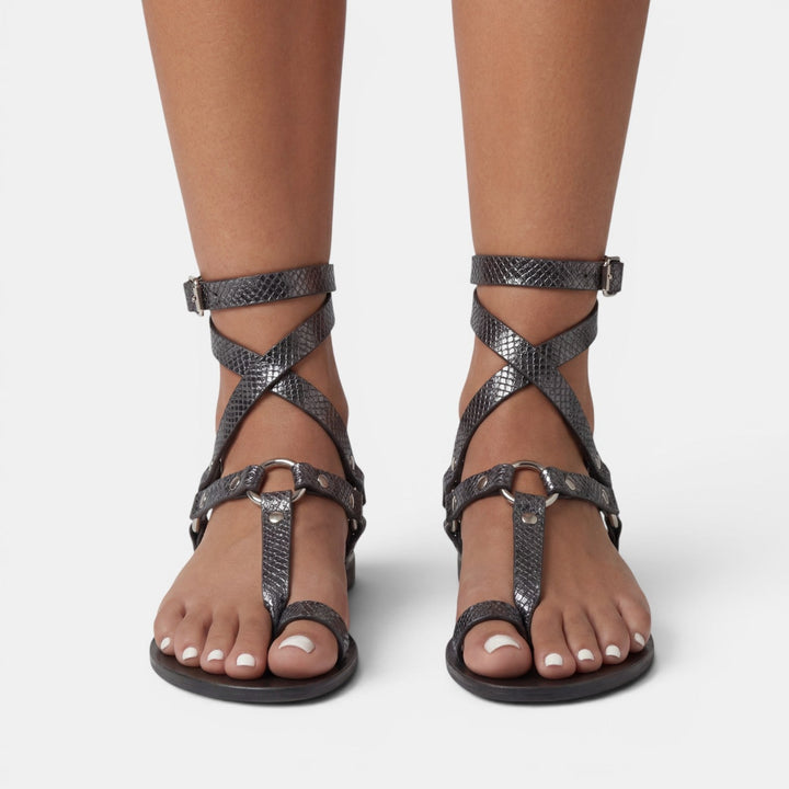 Fashionable women's snake print flat sandals, featuring buckled crossover straps, comfortable and trendy.