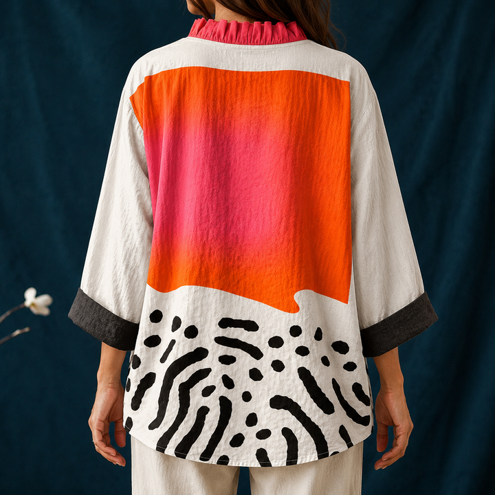 Stylish women's button-up blouse with an abstract block pattern, long sleeves, and a chic ruffled collar for casual style.