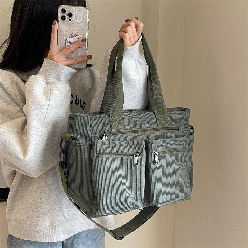 Women's crossbody corduroy bag, showcasing an alternative carrying style with an adjustable strap.