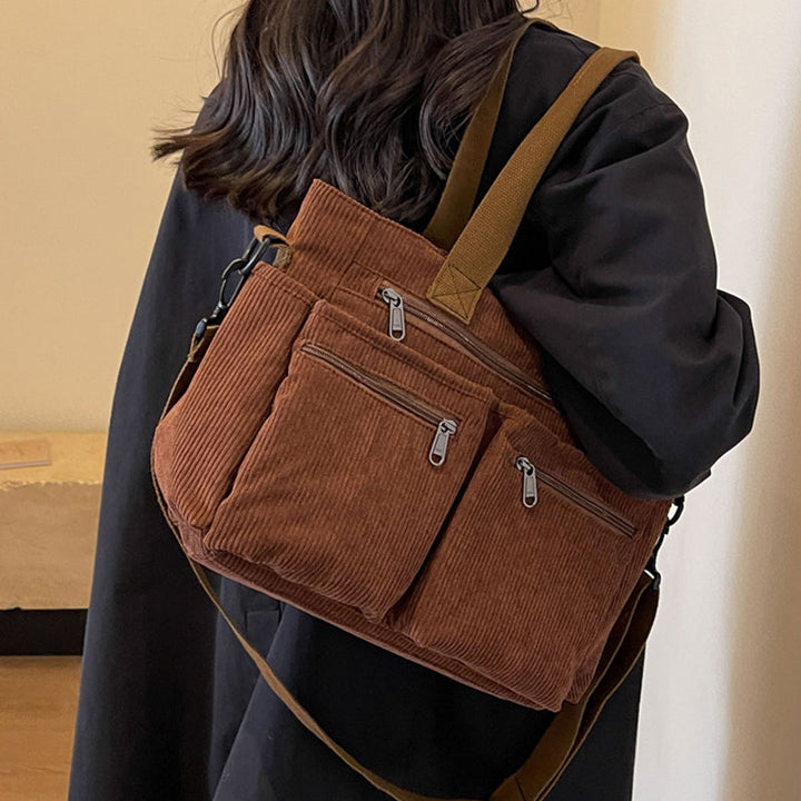 Open casual corduroy tote bag revealing its spacious interior, great for carrying multiple items.