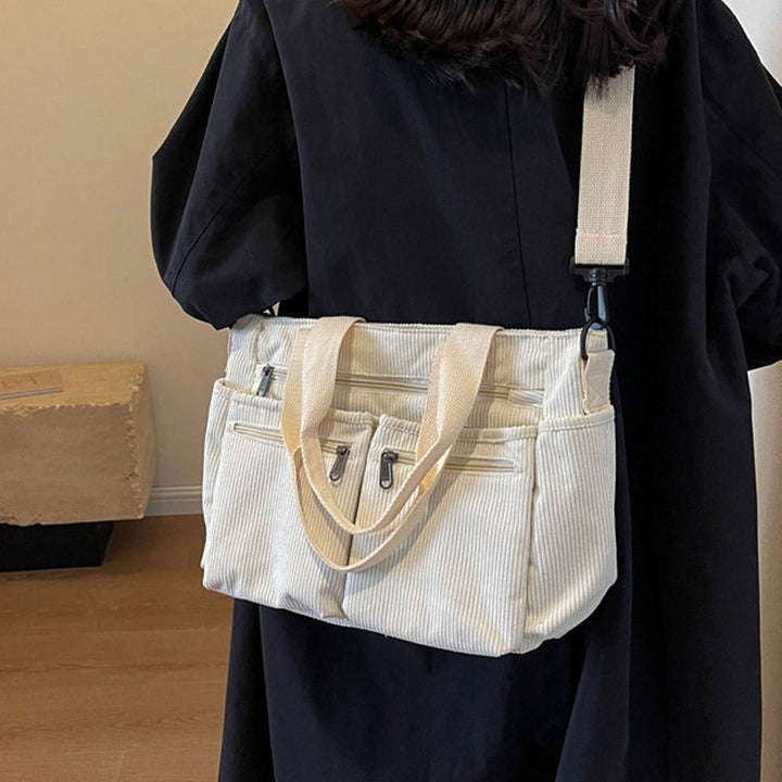 Model carrying a women's large capacity corduroy tote bag, demonstrating its comfortable fit.