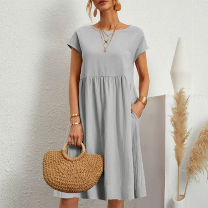 Simple yet stylish women's round neck cotton midi dress, perfect for relaxed summer looks.