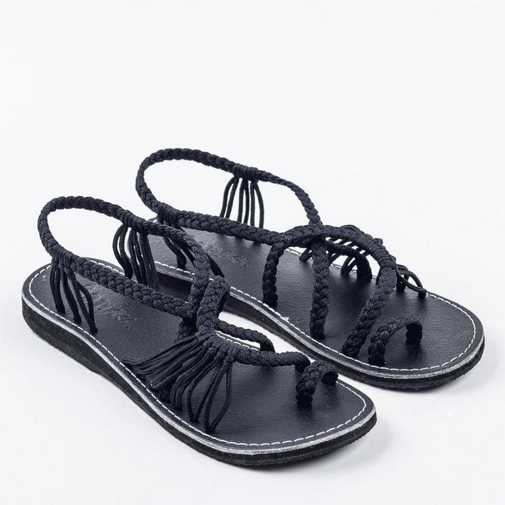 Boho casual women's flat sandals, handcrafted with a charming palm leaf embellishment for summer.