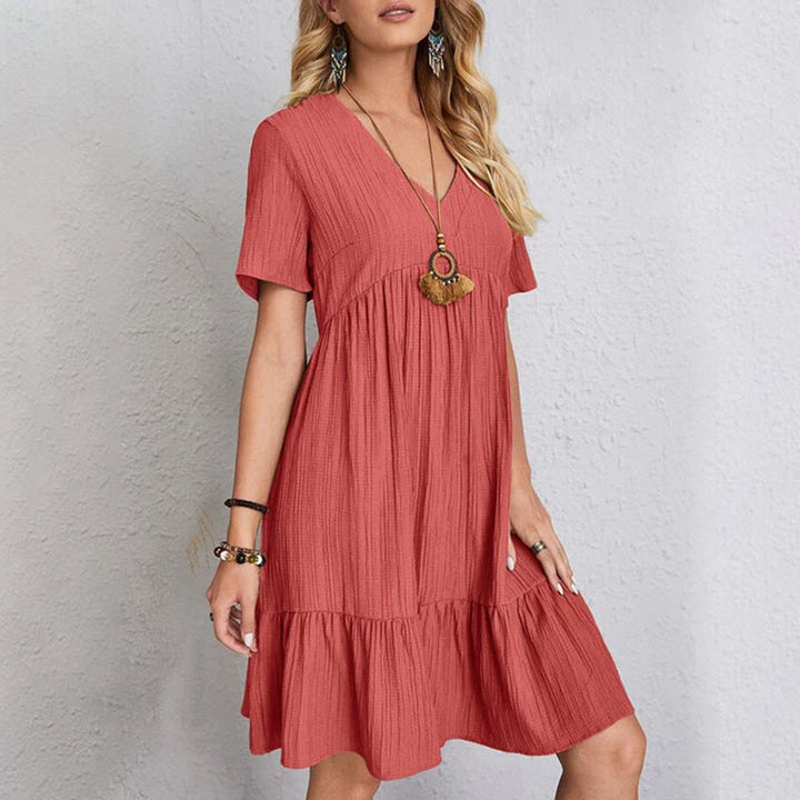 Close-up of the fabric texture of a comfortable flowy mini dress made from soft polyester for women.