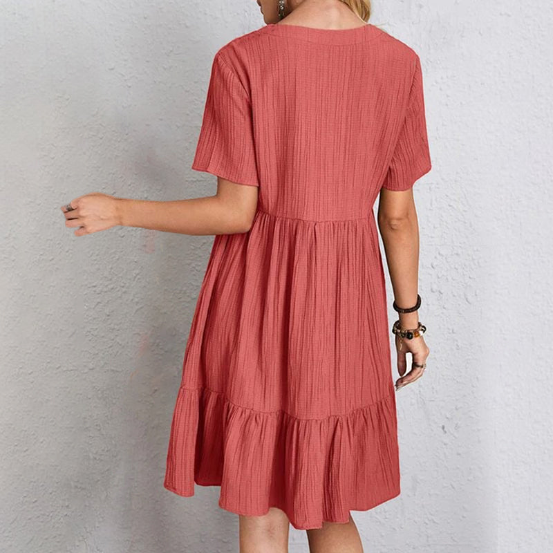 Back view of a women's loose fit casual mini dress, showcasing its comfortable and flowy design.
