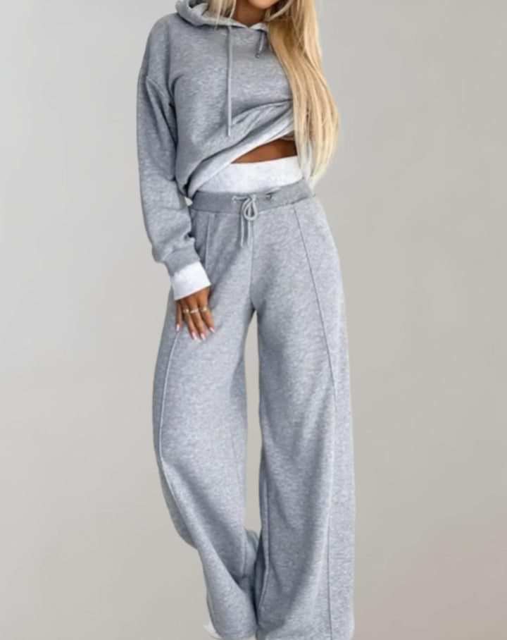 Front view of a woman wearing a relaxed fit women's casual hoodie and jogger tracksuit