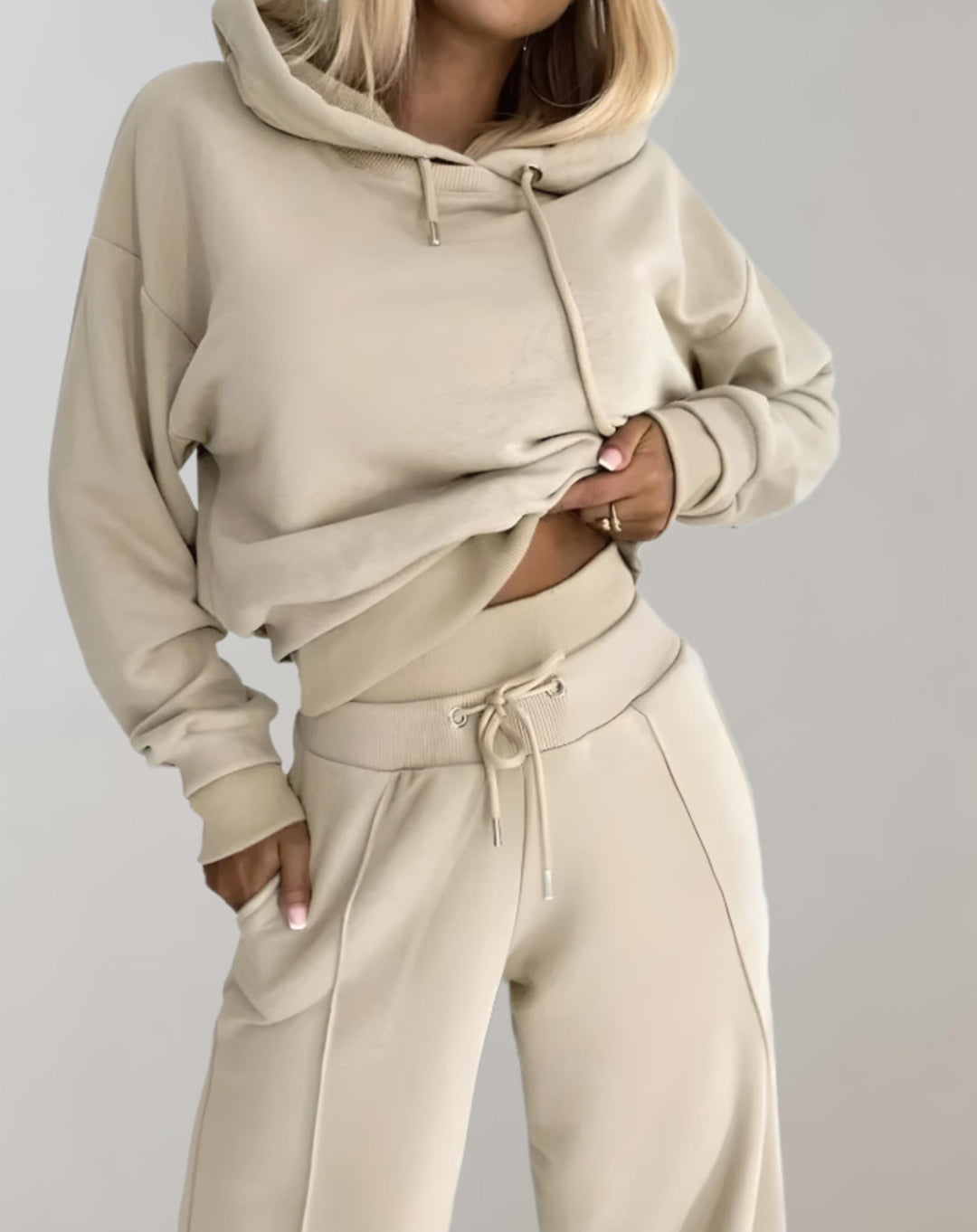 Side profile of a woman showcasing the relaxed silhouette of the women's jogger and hoodie set