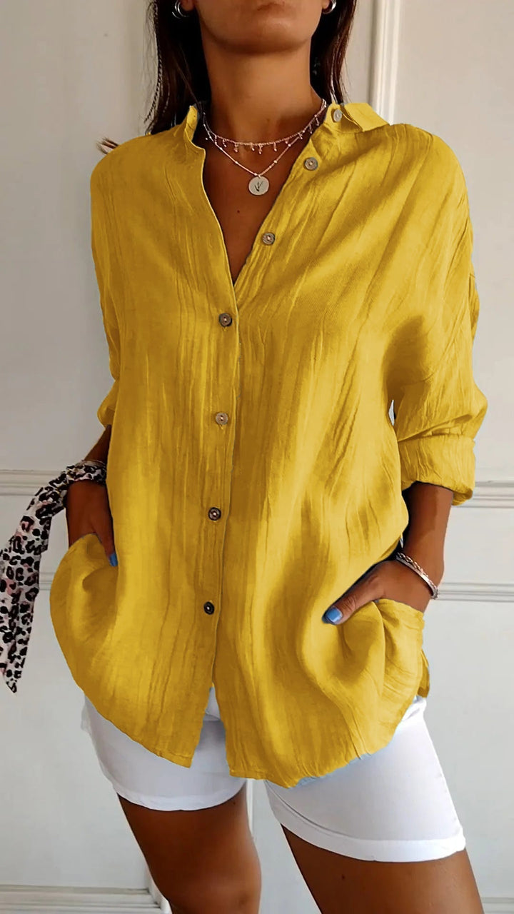 Versatile women's button-down long sleeve top, great for beach cover-up or spring fashion.