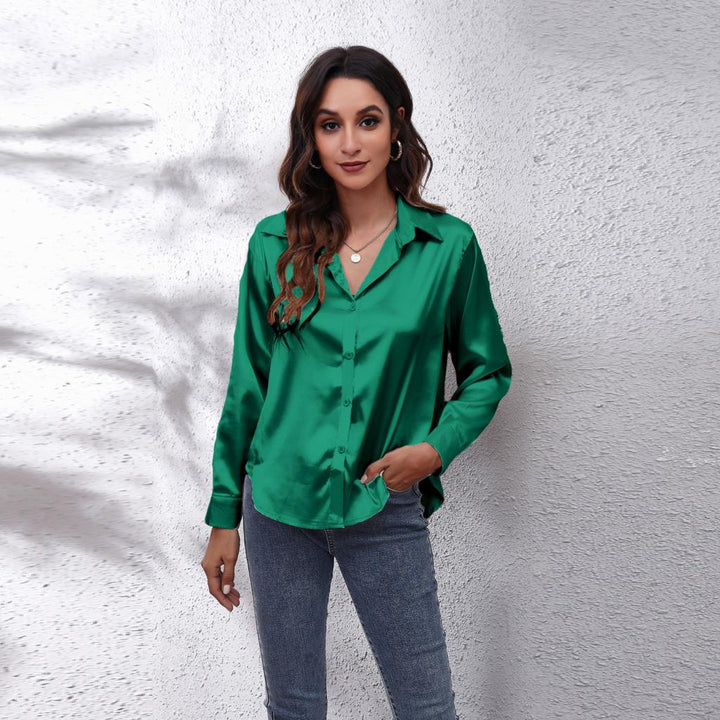 Close-up of the silky fabric on a women's casual loose fit satin button-down blouse