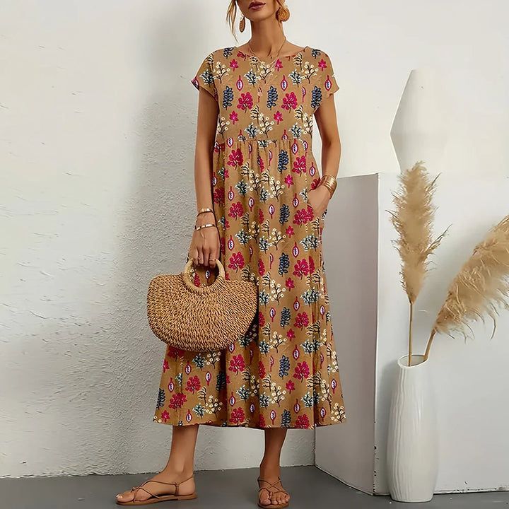 Women's casual midi dress with round neck, cap sleeves, relaxed fit. Effortless spring/summer style.