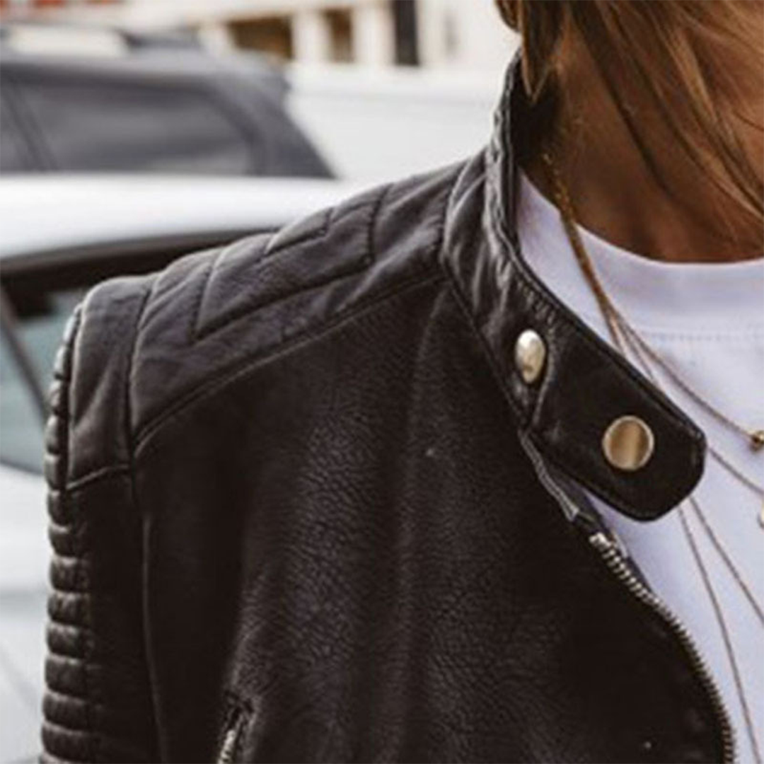 Close-up of a women's biker style jacket, highlighting the quality zipper and durable fabric, versatile.