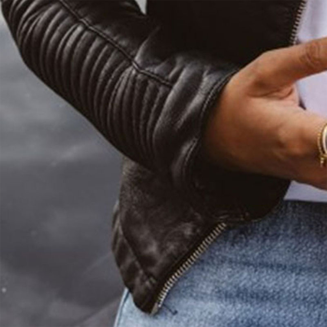 Stylish women's black moto jacket, a casual outerwear piece with edgy zipper details for spring/fall fashion.