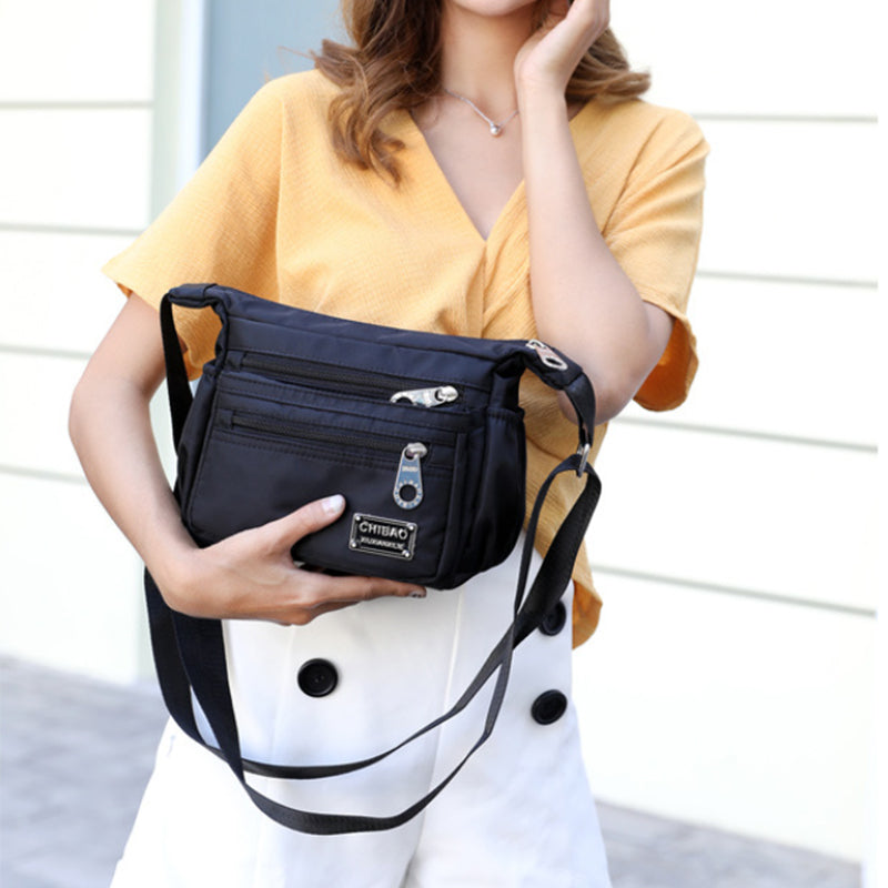 Front pocket detail of the women's casual nylon crossbody bag, ideal for quick access items