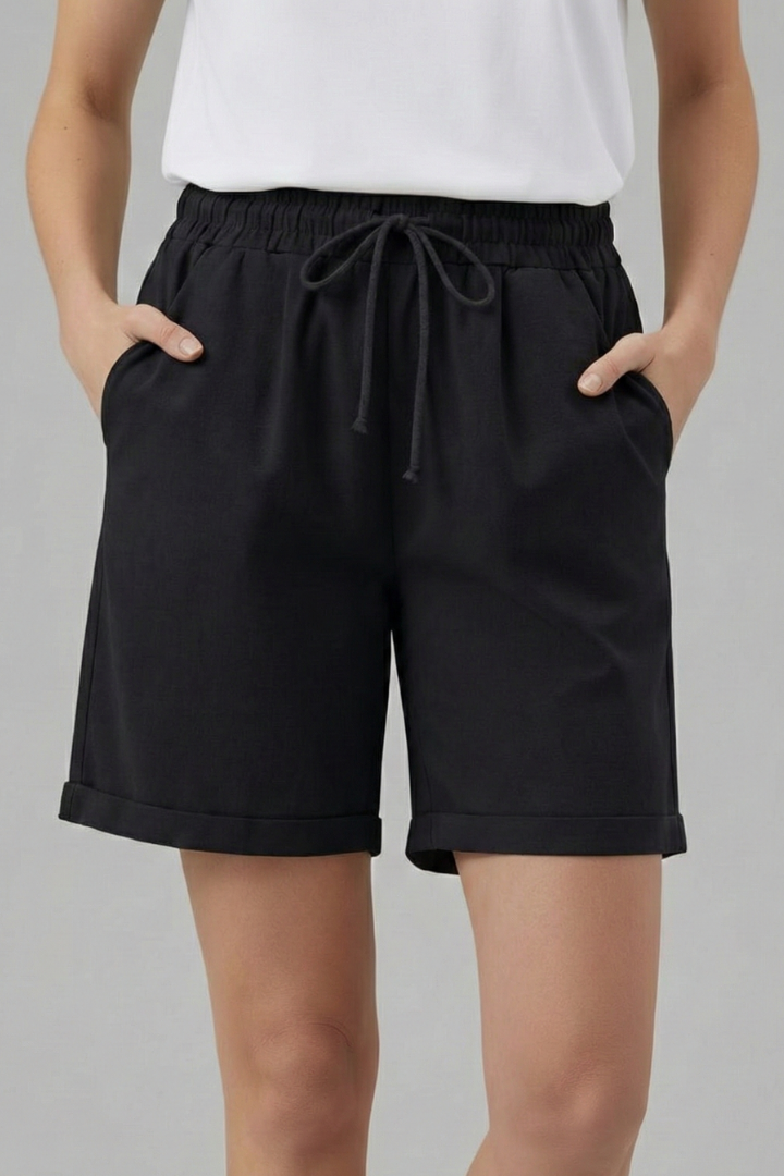 Close-up: Elastic waist & adjustable drawstring on women's comfortable casual shorts with cuffed hem.