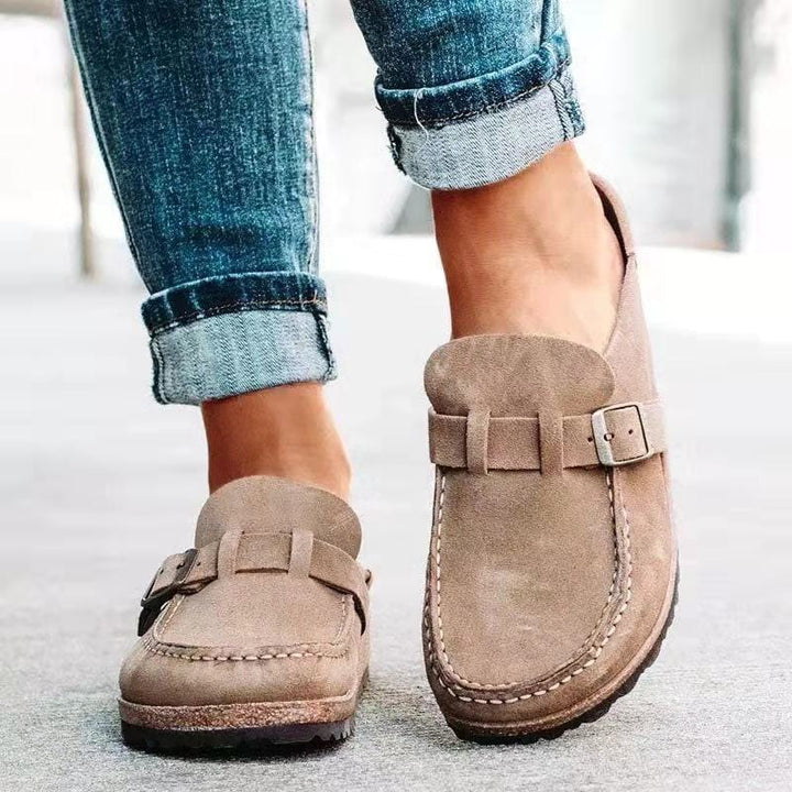 Close-up of a women's slip-on loafer showing the buckle embellishment and comfortable design.