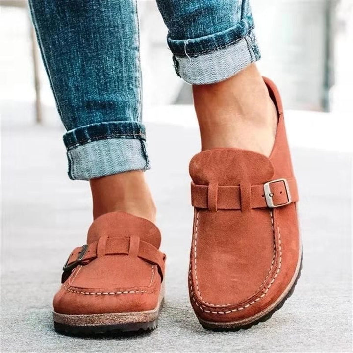 Fashionable women's buckle loafers in a neutral color, great for comfortable everyday wear.