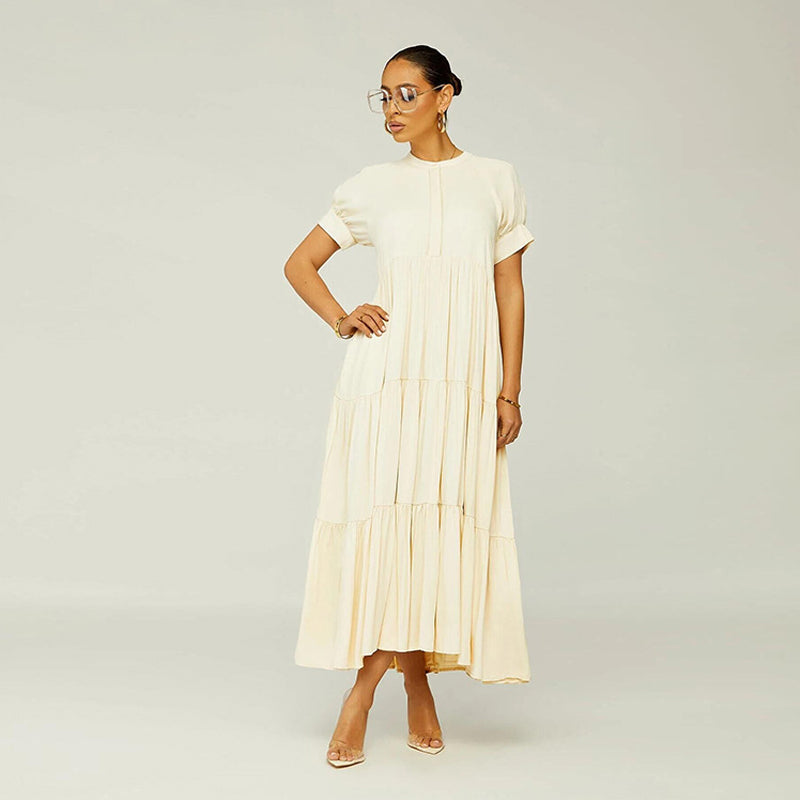 Front view of a loose fit women's casual spandex midi dress with short sleeves and tiered design