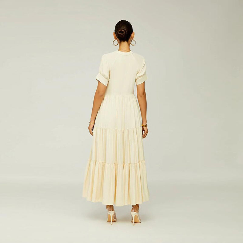 Back view of a fashionable women's tiered midi dress, ideal for summer, made of spandex