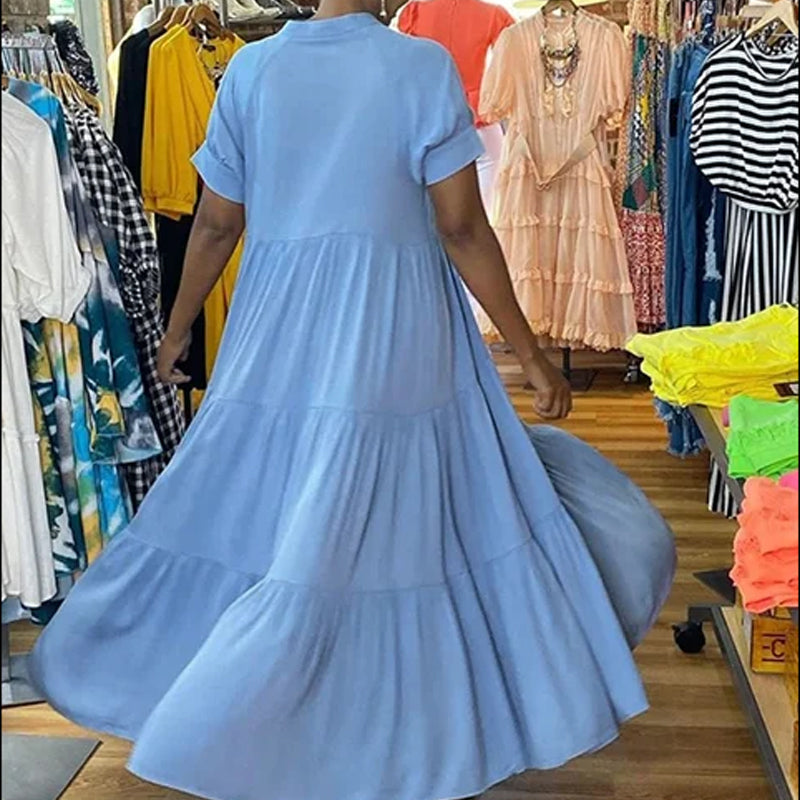 Close-up of the fabric and tiered detail on a women's casual spandex midi dress, short sleeve
