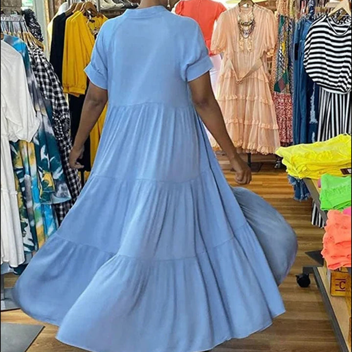 Close-up of the fabric and tiered detail on a women's casual spandex midi dress, short sleeve