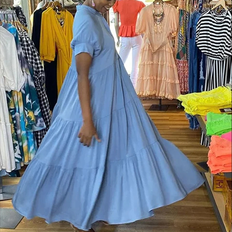 Side profile of a women's casual short sleeve midi dress with a flowing tiered design in spandex