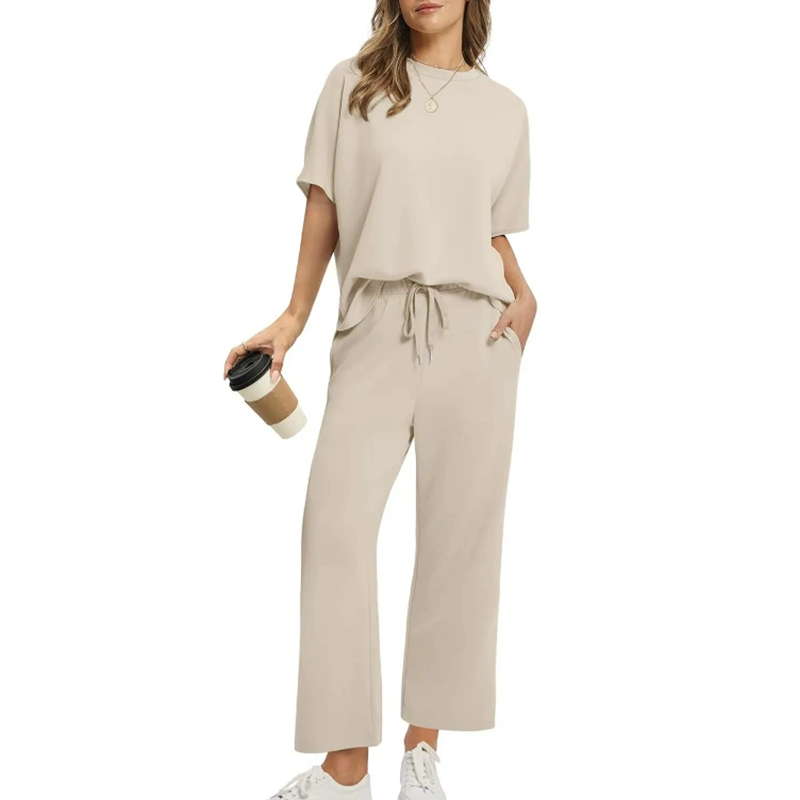 Women's casual two-piece lounge set with pockets, featuring a relaxed fit top & wide-leg drawstring pants.