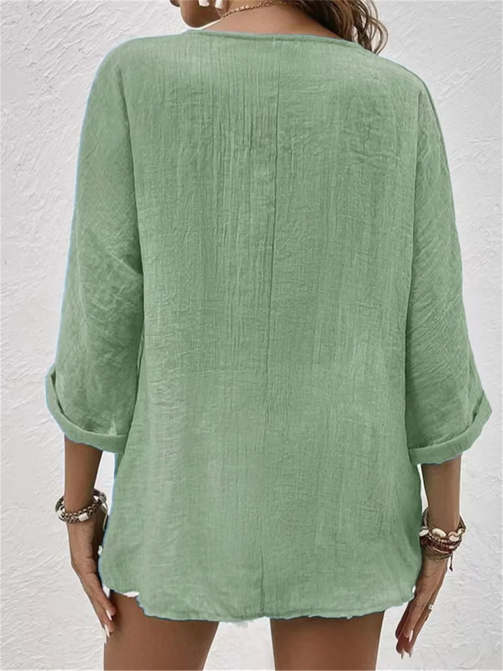 Versatile women's casual blouse for spring/summer. Features a V-neck and button front. Three-quarter sleeves.