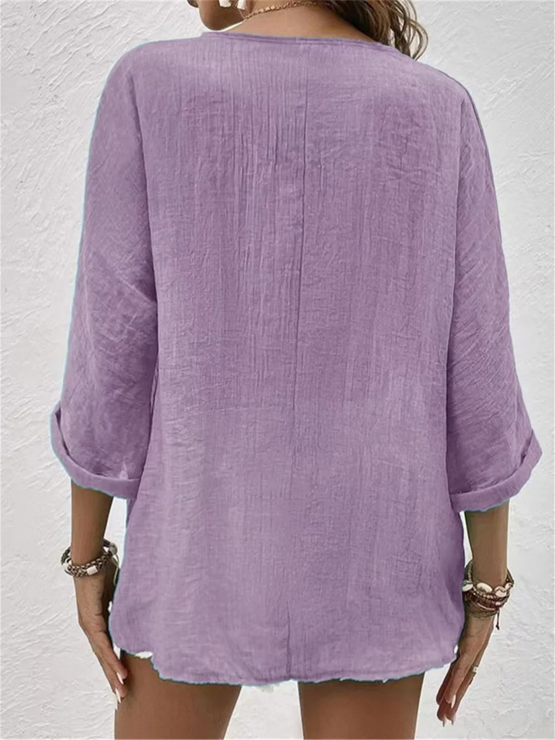 Front view: Women's casual V-neck button-front top, solid color. Relaxed fit and three-quarter sleeves for comfort.