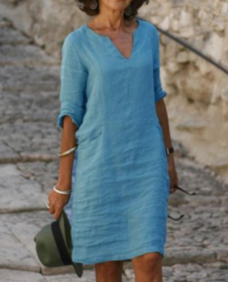 Flowy V-neck midi dress for women, 3/4 sleeves, comfortable fit, essential for casual summer fashion.