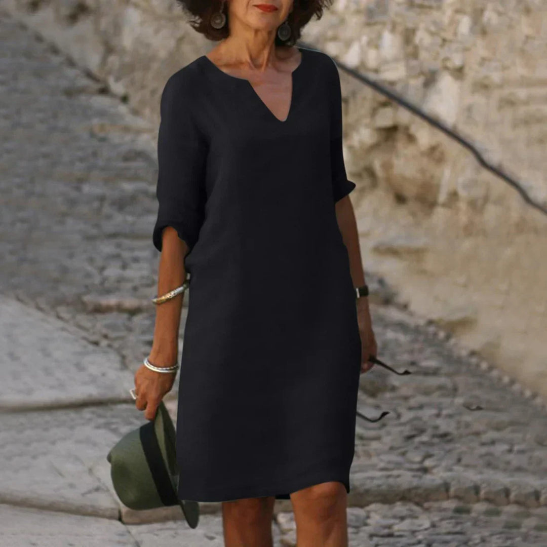 Comfortable women's V-neck shift dress, knee-length, ideal for warm weather relaxed fit.
