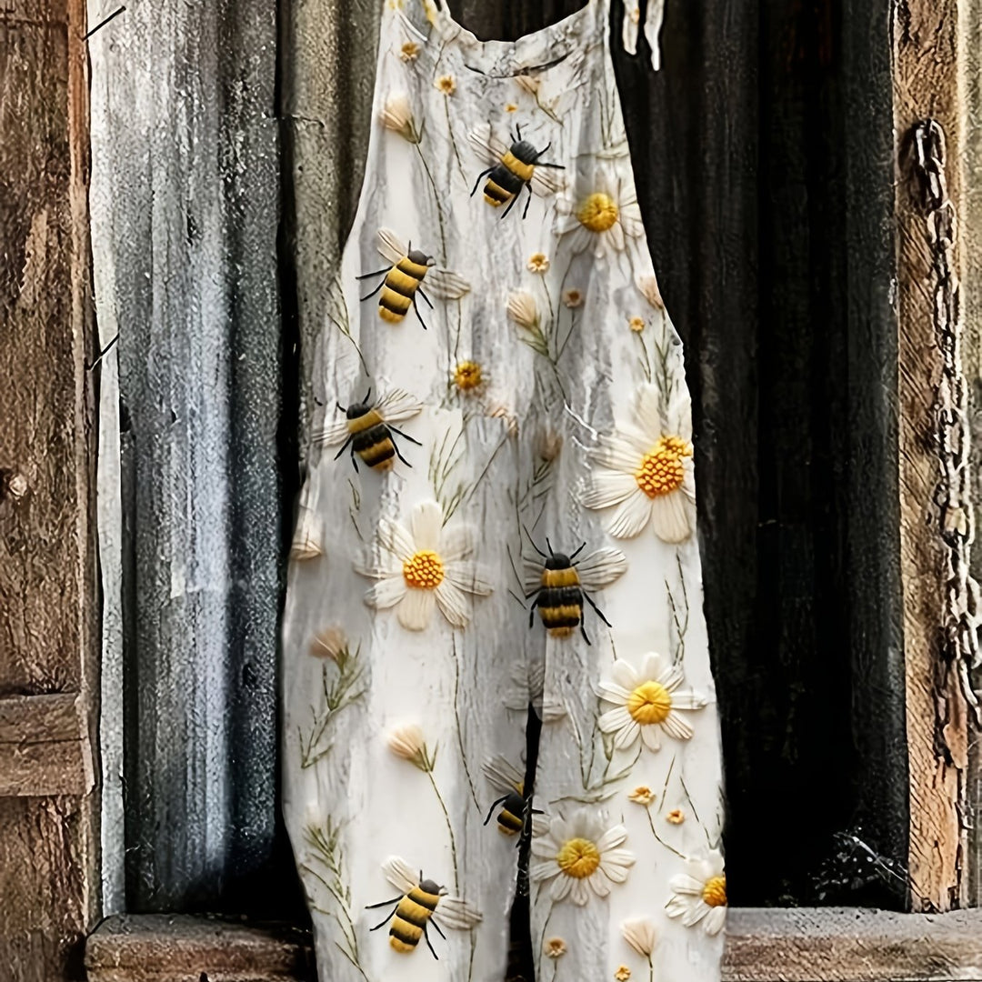 Detailed view of the whimsical daisy and bee print fabric on a women's casual summer jumpsuit.
