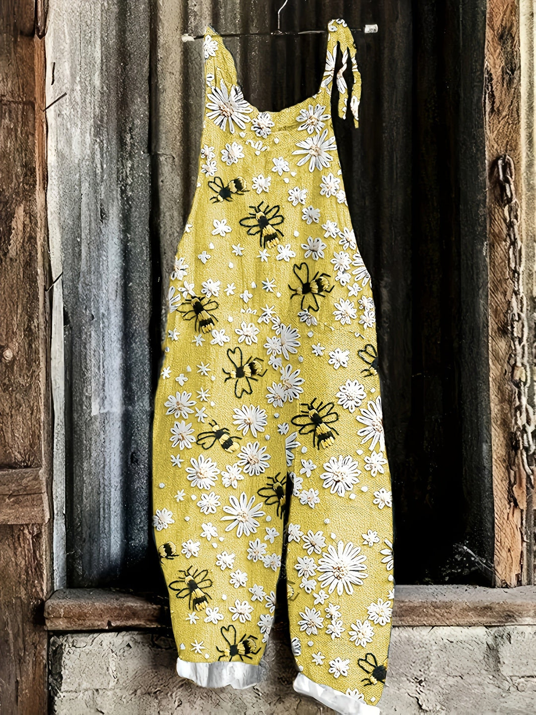 Whimsical daisy and bee print women's casual wide-leg jumpsuit, sleeveless, ideal for summer comfort.