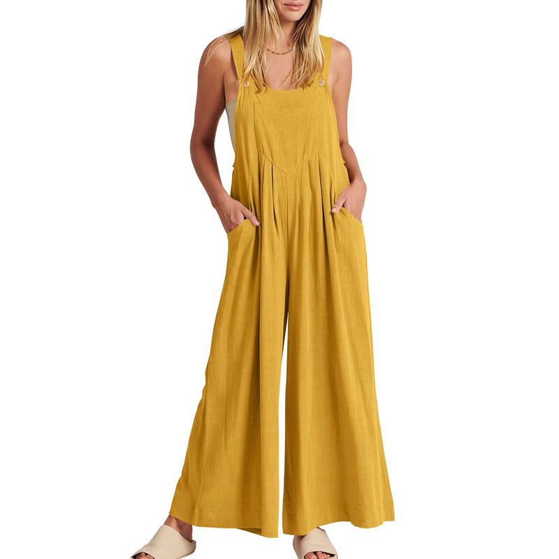Studio shot of a women's black wide leg sleeveless jumpsuit, highlighting its flowy design.