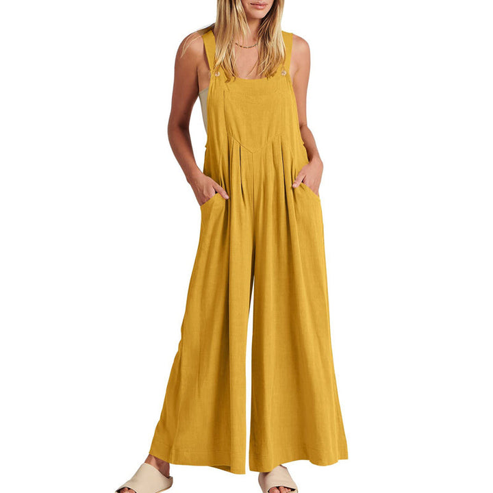 Studio shot of a women's black wide leg sleeveless jumpsuit, highlighting its flowy design.