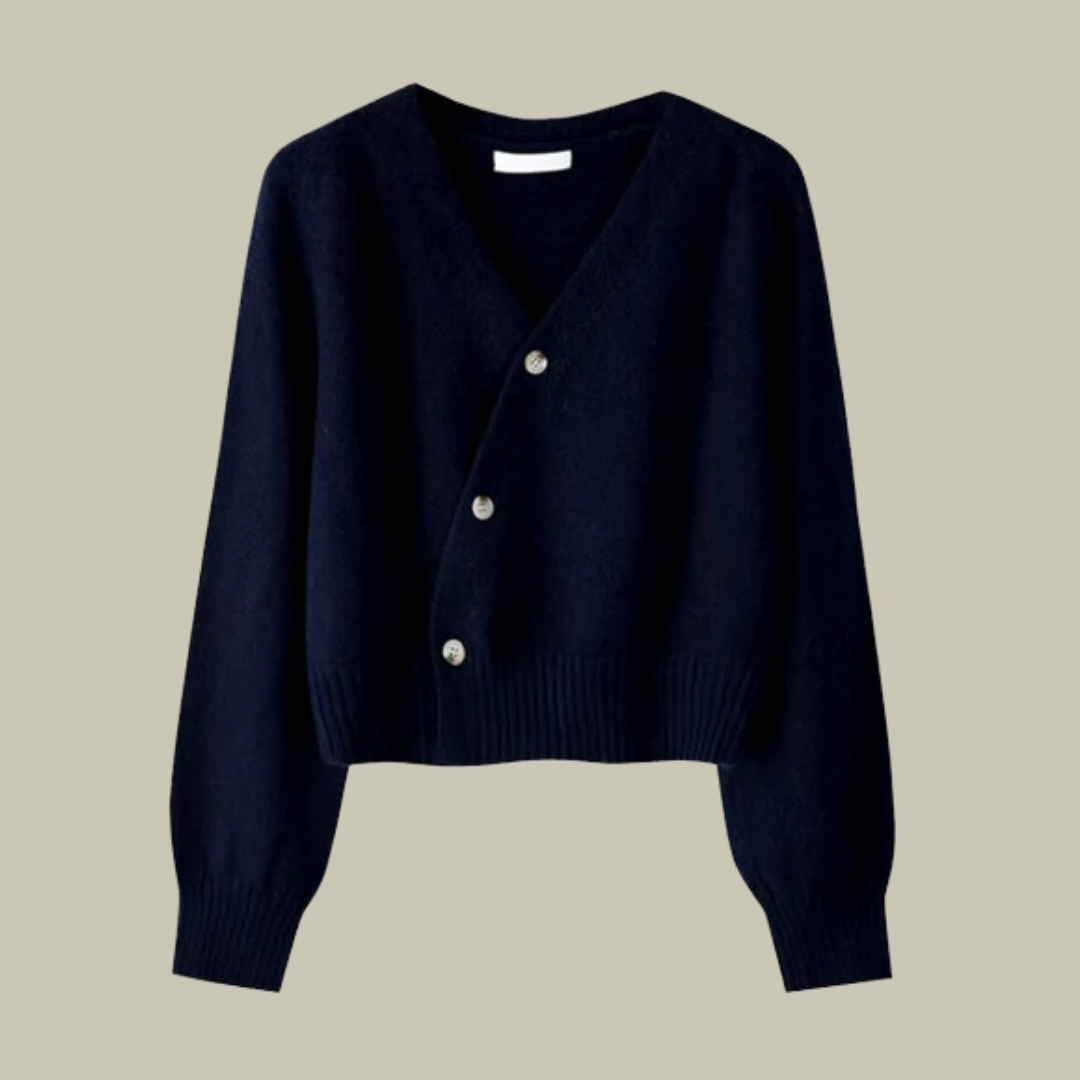 Close-up of the cross button detail on a women's v-neck merino wool blend sweater.