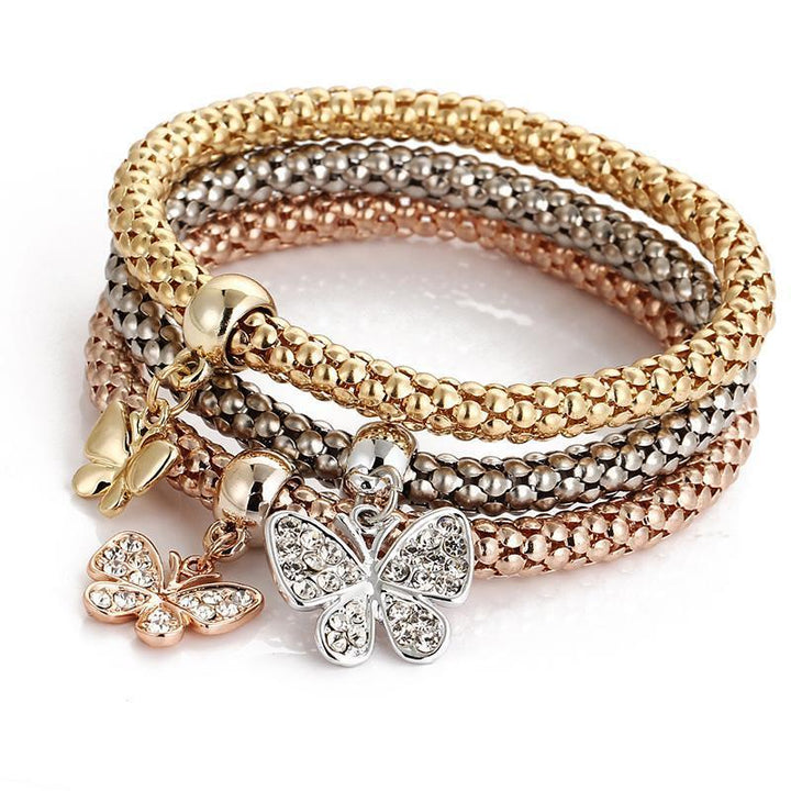 Elegant women's rhinestone and charm bracelet set on a white background, highlighting its sparkle