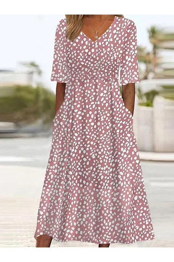 Women's charming pink polka-dot V-neck summer dress with elbow sleeves, A-line fit & pockets, perfect for warm weather.