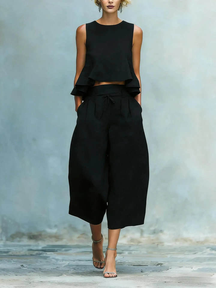 Modern women's matching crop top and wide leg pant suit. Effortlessly stylish for summer casual or dressy wear.