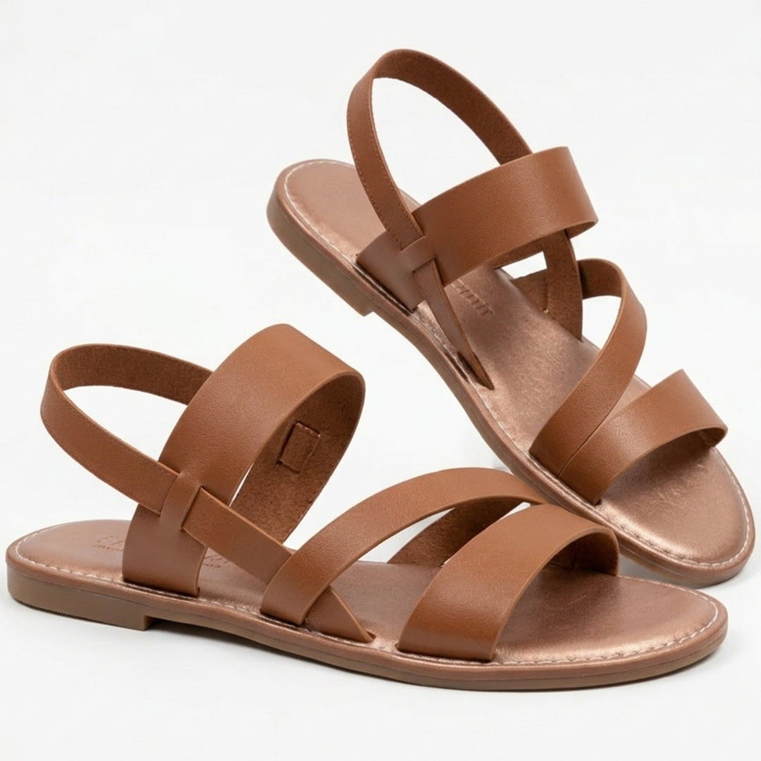 Women's chic flat sandals with crossover straps, perfect for summer vacation.